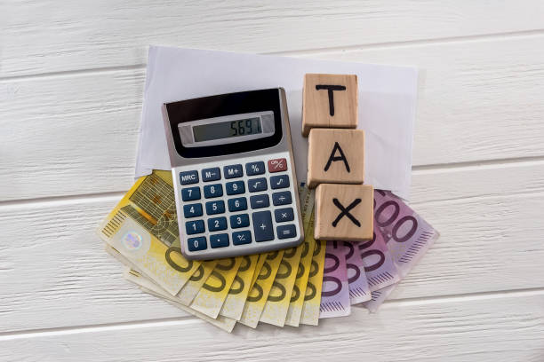 istock Euro banknotes with calculator on light background 1127399045