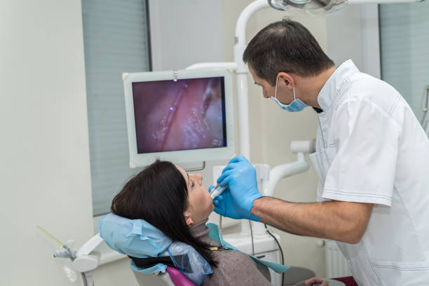 dentista, verificando os dentes do paciente com câmera em estomatologia - medical exam dental hygiene caucasian mask - fotografias e filmes do acervo