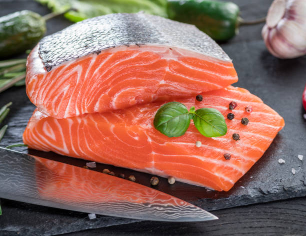 istock Fresh salmon fillets on black cutting board. 1127400180