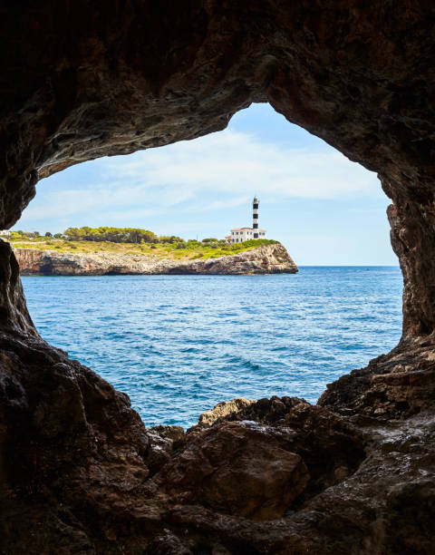 istock Portocolom Lighthouse seen from a cave, Mallorca. 1127400266