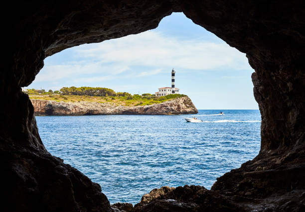istock Portocolom Lighthouse seen from a cave, Mallorca. 1127400288