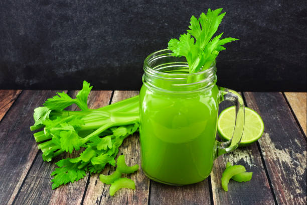 istock Celery juice in a mason jar against a dark wood background 1127401155
