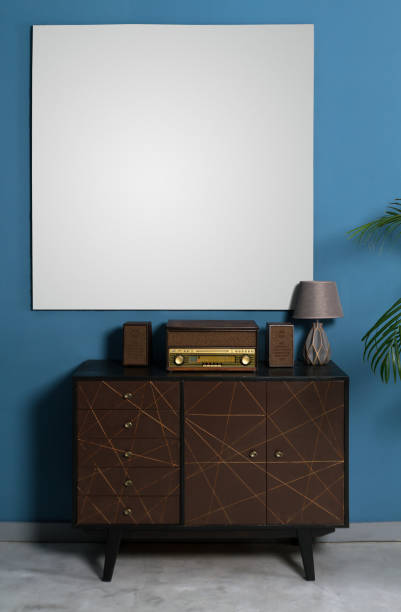 istock Retro style radio on drawers cabinet and empty white frame 1127402128