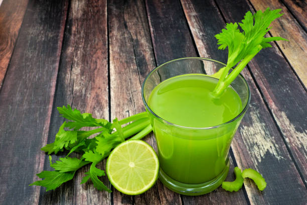 istock Celery juice in a glass over a rustic dark wood background 1127402505