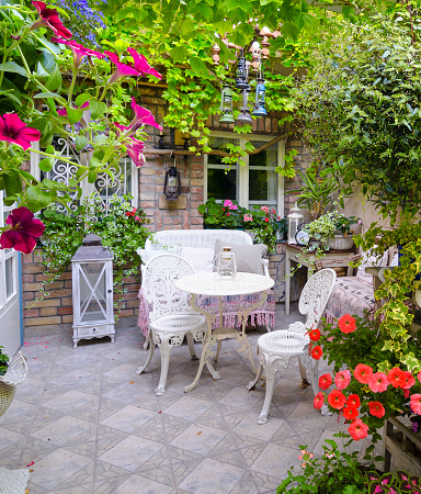 Beautiful home garden in antique yard on a sunny summer day.