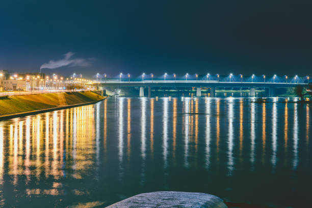 istock Illuminated Buildings By Sea Against Sky At Night 1127405485