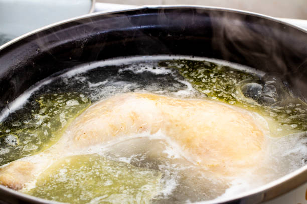 istock boiled chicken in a pot broth close-up with blurred background and front 1127405929