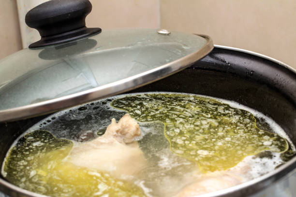 boiled chicken in a pot broth close-up with blurred background and front boiled chicken in a pot broth close-up with blurred background and front boiled water stock pictures, royalty-free photos & images