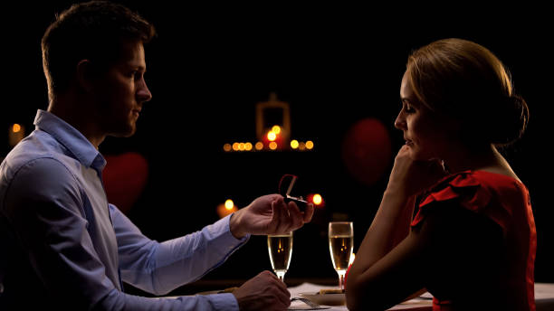 istock Male proposing marriage his girlfriend during romantic evening in restaurant 1127406052