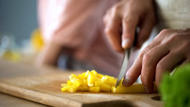 istock Chef cutting fresh pepper on kitchen board, culinary tips, salad ingredients 1127406223