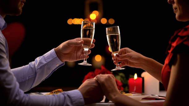 istock Nice couple holding hands, drinking champagne during romantic date, anniversary 1127406319