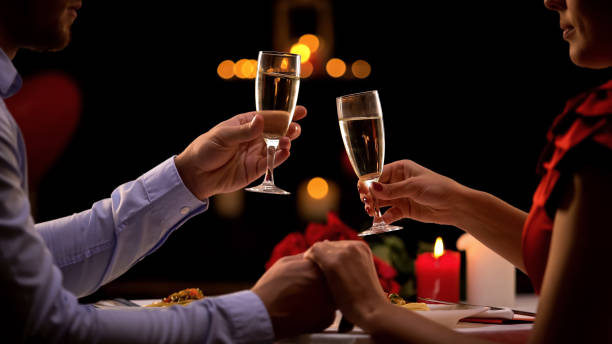istock Couple drinking champagne in restaurant, romantic date on st valentines day 1127406329