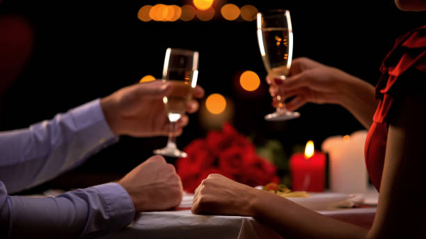 istock Young couple with champagne on romantic evening, celebrating anniversary, love 1127406442