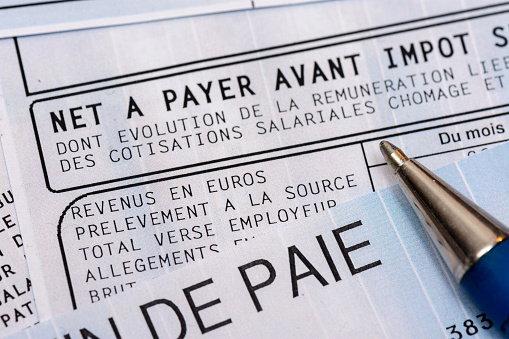 Close up on a french payroll with social contributions and income tax deduction, mandatory in France since January 2019