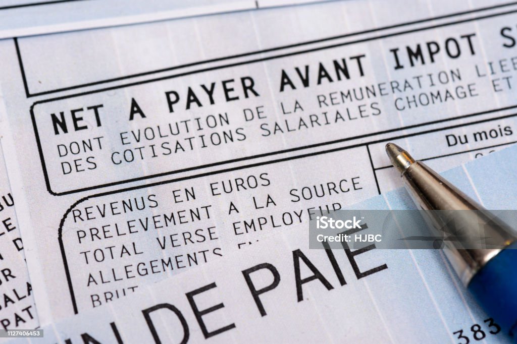 French payroll with income tax deduction Close up on a french payroll with social contributions and income tax deduction, mandatory in France since January 2019 Paycheck Stock Photo