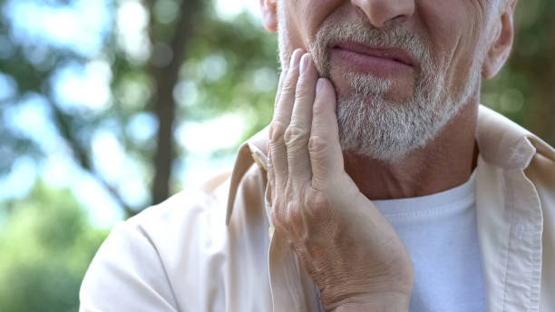 istock Dental pain, retired man suffering from toothache, teeth prosthetics, dentistry 1127406530