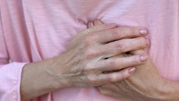 istock Woman holding hands on chest, sudden heart attack, health problem, emergency 1127406907