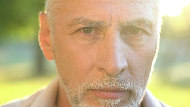 istock Grey-haired male pensioner looking into camera, social security and retirement 1127406956