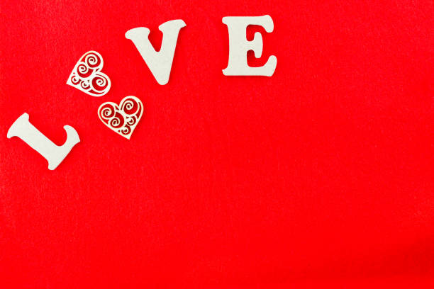 istock Word LOVE created using wooden letters and heart on red for Valentines 1127408334