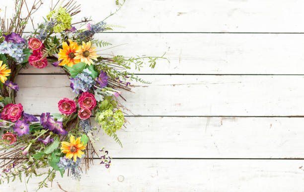 istock Easter spring flower wreath on an old rustic white wood background 1127411145