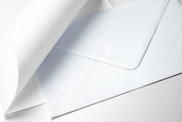 istock Blank sheet of paper with curled corner and envelope 1127413077