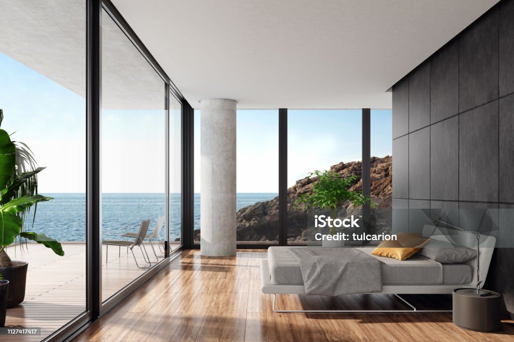 Moderna camera da letto lussuosa in una villa sul mare con muro di pietra nera - Foto stock royalty-free di Lusso