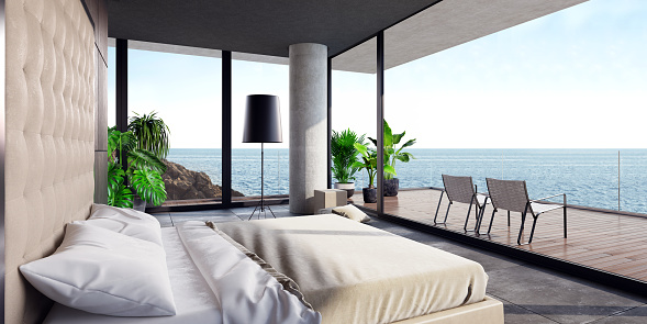 Luxurious minimalist bedroom in a villa by the ocean with big panoramic windows
and a spectacular view. Big white textile bed with high headboard and white 
linen. Big modern black floor lamp and plants. Black ceiling, natural stone 
floor tiles. 
A big terrace with an ocean view, wooden floor and glass fence. Two modern relaxing
lounge chairs on the terrace. Summer day scene.
Background is my own photo.