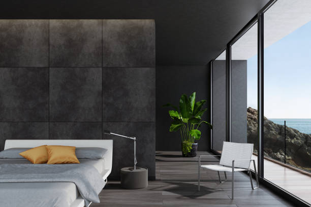 Modern luxurious black bedroom in a villa by the ocean