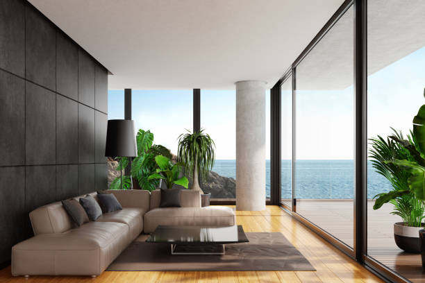 istock Modern minimalist living room with big panoramic ocean view 1127418567