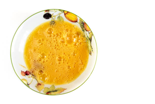 istock Beaten egg yolks in the plate isolated on white background. 1127418646