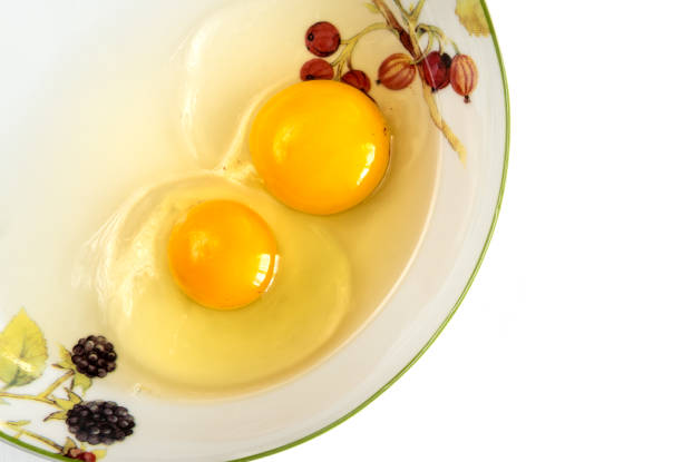 istock Raw egg yolks in the plate isolated on white background. 1127420376