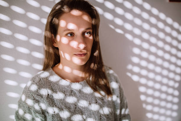 istock Pretty Brunette Woman Behind Sun-blind Shadow 1127420623