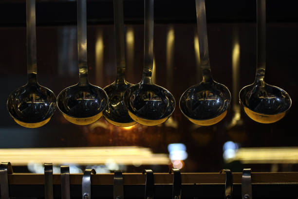 Shiny ladles in a dark kitchen