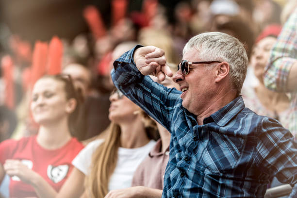 istock Mature man in a stadium crowd 1127427739