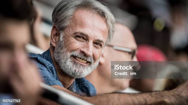 Middleaged Grayhaired Man Smiling And Looking At Camera - Fotografias de stock e mais imagens de Estádio