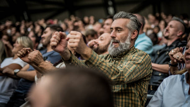 istock Middle-aged man enjoying himself at a sports match 1127427789