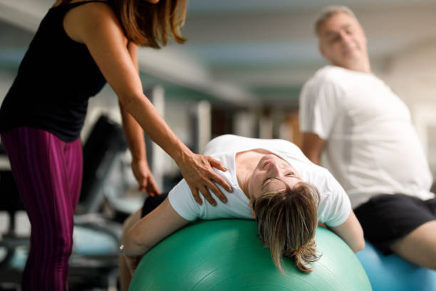 istock Personal trainer helping senior couple 1127428717
