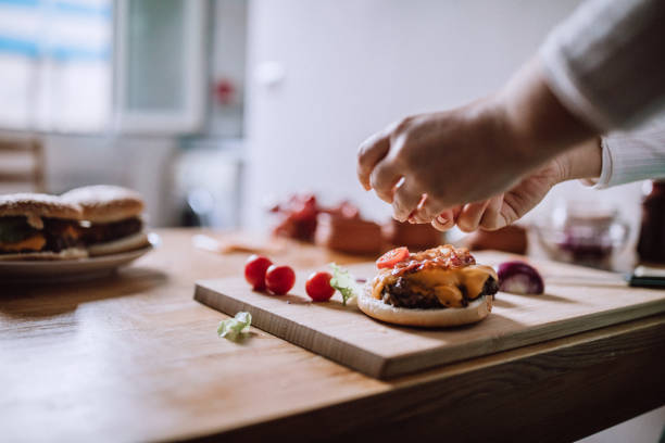 istock Adding Fresh Veggies To Delicious Burgers 1127429865