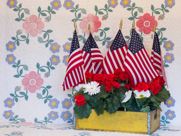 Americana Wood Crate Crate of American flags and flowers on vintage quilt patriotic quilt stock pictures, royalty-free photos & images