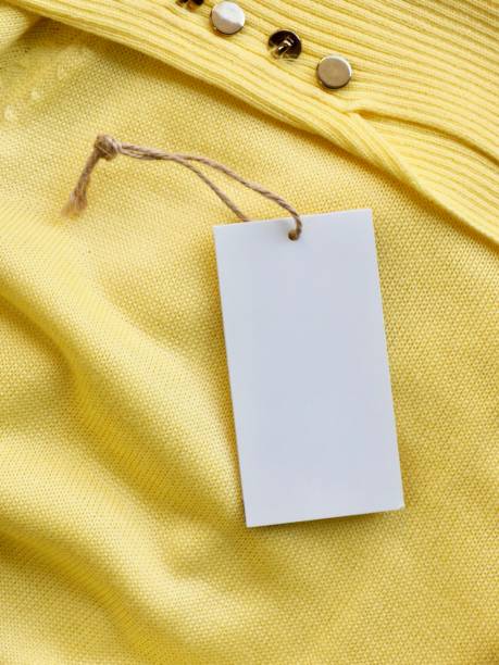 Yellow spring sweater and clothing label Shot in studio 가까운 stock pictures, royalty-free photos & images