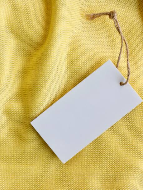 istock Yellow spring sweater and clothing label 1127436552