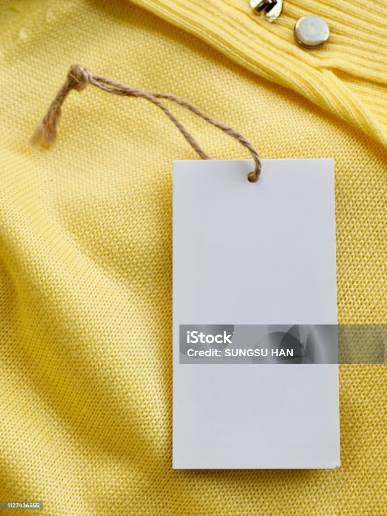 Yellow spring sweater and clothing label Shot in studio Abstract Stock Photo