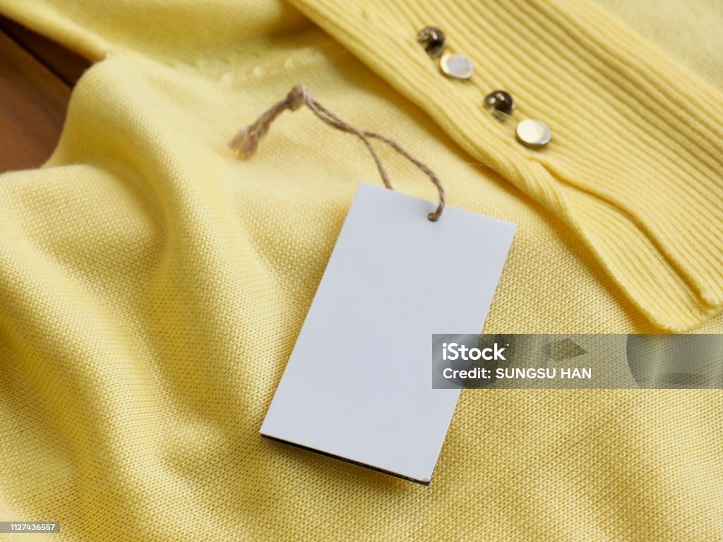 Yellow spring sweater and clothing label Shot in studio Abstract Stock Photo