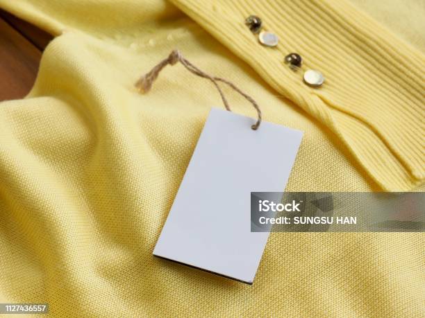 Yellow Spring Sweater And Clothing Label Stock Photo - Download Image Now - Abstract, Abstract Backgrounds, Art