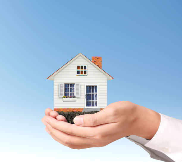 istock Mortgage concept by house  in hand 1127438957