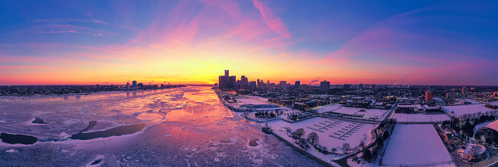 Aerial view of Frozen Detroit river with city skyline in Winter