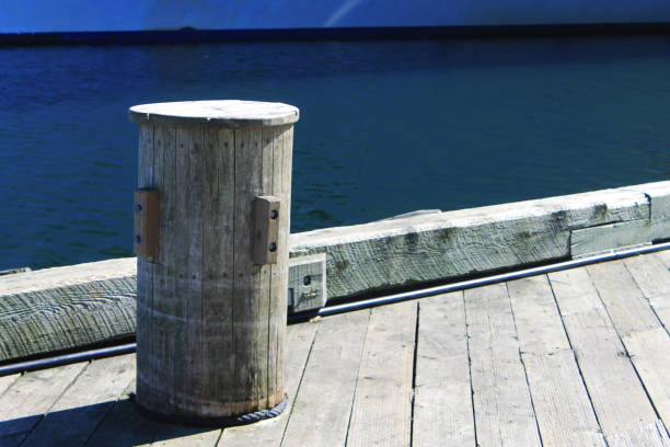 istock Wooden bollard on a commercial dock. 1127443489