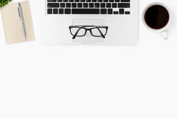istock White office desk table with laptop, coffee cup and supplies. Top view with copy space, flat lay. 1127445590