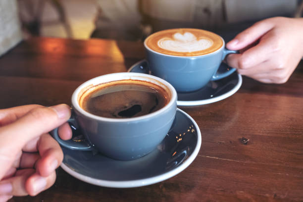 istock a man and a woman clinking blue coffee mugs 1127448259