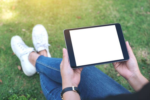 istock a woman holding and using black tablet pc with blank white desktop screen 1127448261